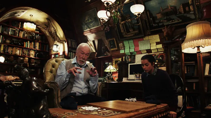 Harlan Thrombey and Marta Cabrera inside the study before the tragic misunderstanding unfolds