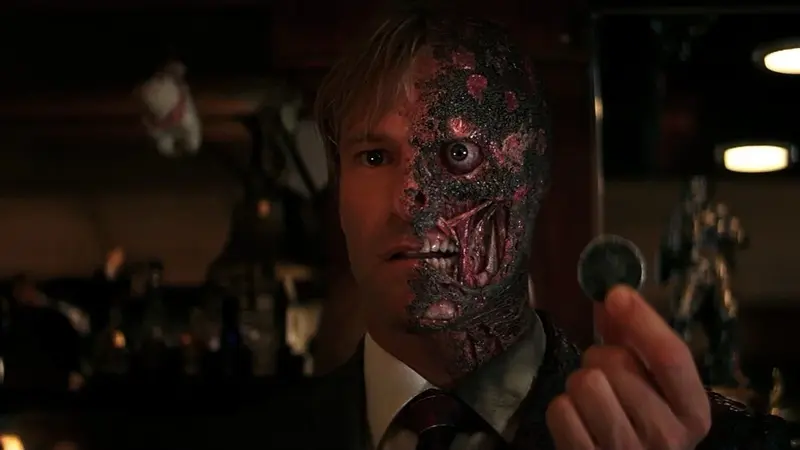 Harvey Dent holds his damaged coin after becoming Two-Face in The Dark Knight (2008)