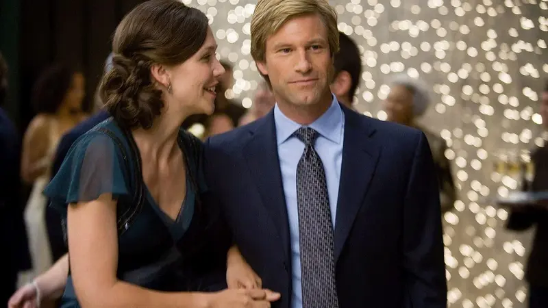 Rachel Dawes and Harvey Dent share a moment together in The Dark Knight (2008)